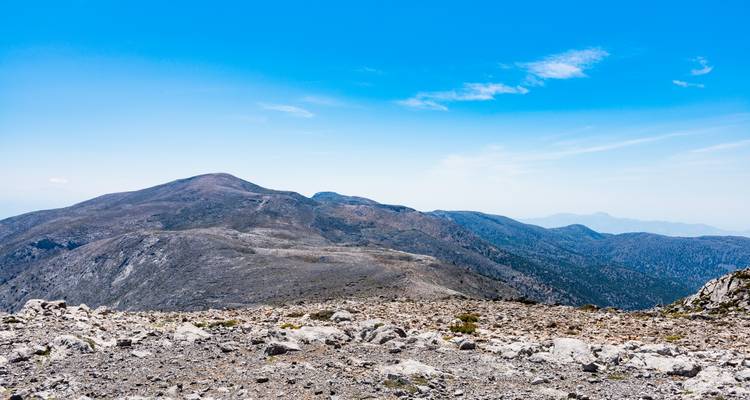 Mountainous terrain under a clear blue sky.