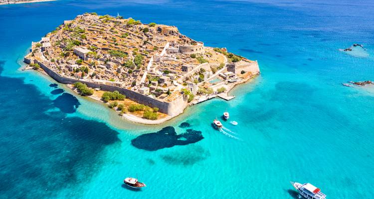 Aerial view of Spinalonga island surrounded by turquoise waters.