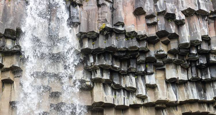 Waterfall cascading over basalt columns.