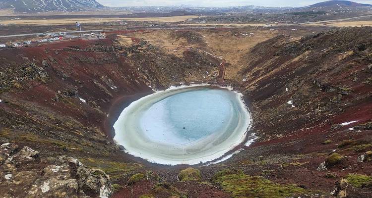Frozen crater lake in a volcanic landscape.