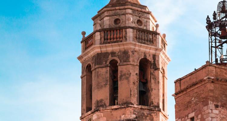 Historic clock tower against a blue sky.