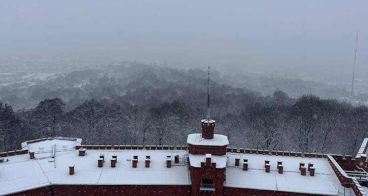 A snowy landscape with a view from the top of a fort.