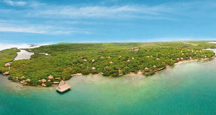 Vue aérienne d'une île avec une végétation luxuriante et les eaux bleues environnantes.