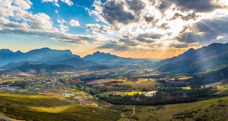 Panoramic view over valley and mountains at sunset.
