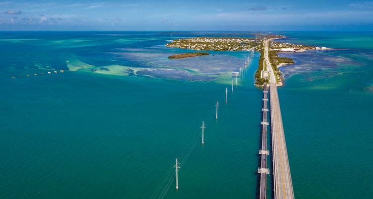 Wide view of a bridge connecting islands over blue waters.