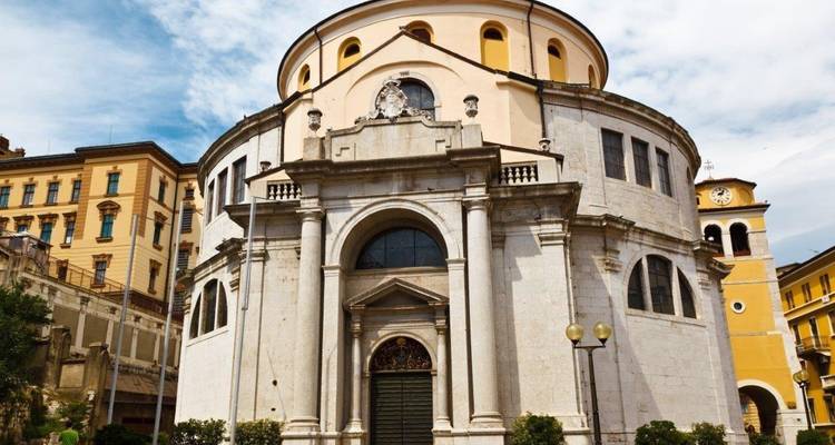 Historic church with a round facade in a city setting.
