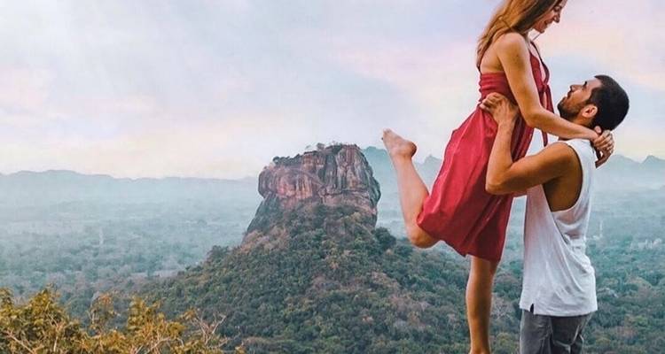 Couple posing with Sigiriya Rock in the background.