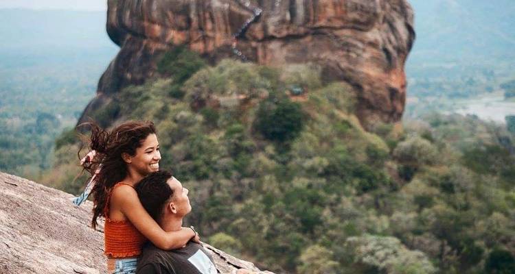 Couple embracing with Sigiriya Rock in the background.