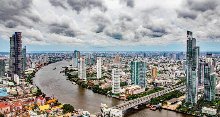 Aerial view of Bangkok city with river and skyscrapers.