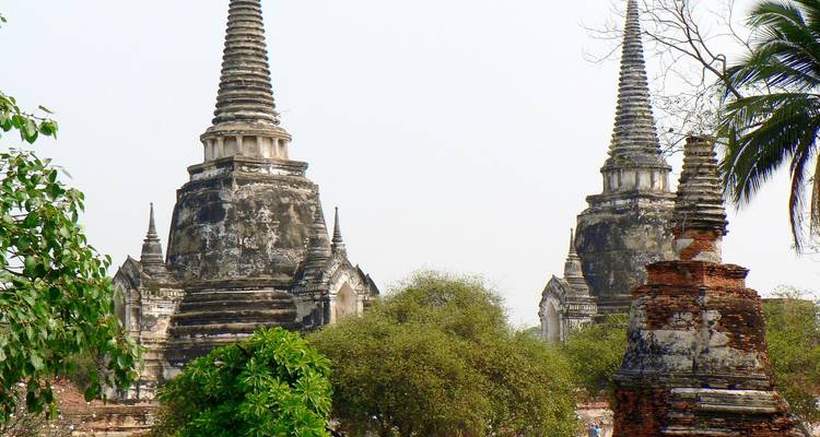 Ancient temple ruins surrounded by trees.