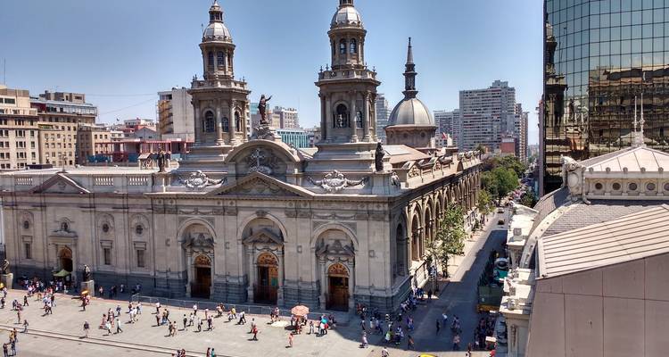 Vue aérienne d'une grande cathédrale et d'une rue de ville animée dans un cadre urbain.