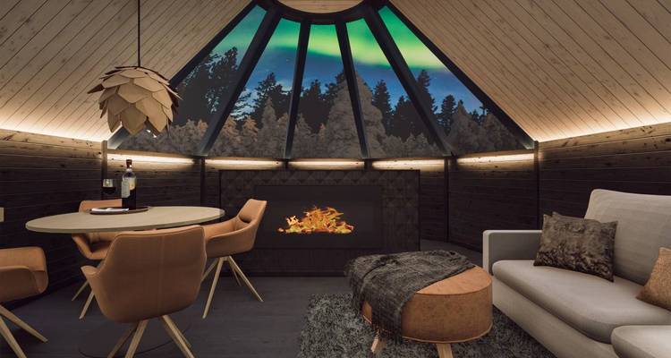 Interior of a cabin with a glass ceiling showing the Northern Lights.