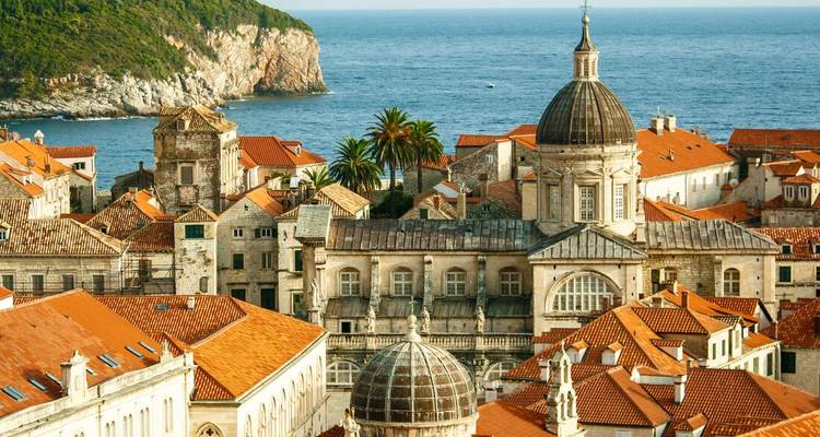 Historic domed cathedral and orange roofs of Dubrovnik with the Adriatic Sea backdrop