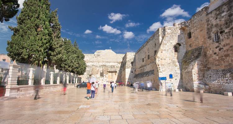 Historic courtyard scene with blurred motion of people.