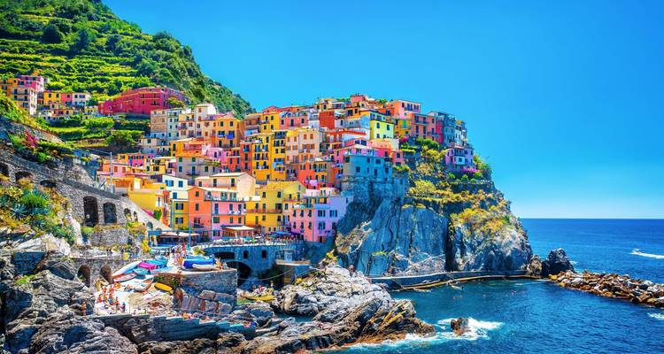 Colorful cliffside village with ocean view.