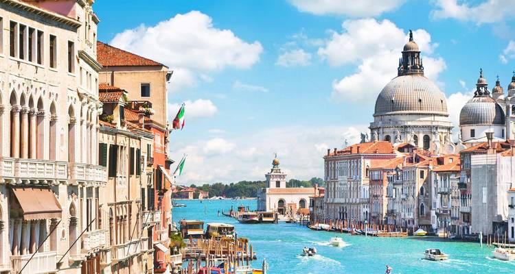 Canal in Venice with historical buildings and grand dome.
