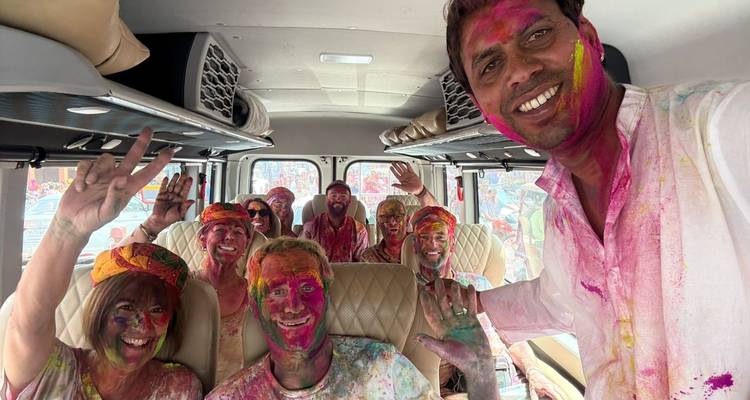 Groupe de personnes avec de la poudre de Holi dans un véhicule.