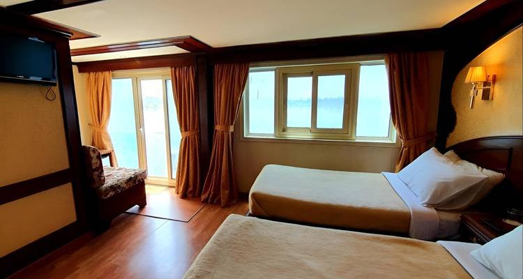 Interior room with twin beds and river view.