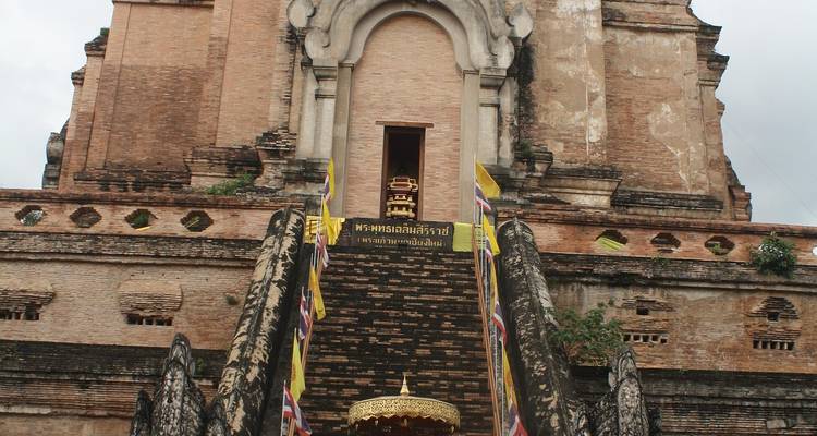 Historic temple with intricate carvings and stairs leading up.