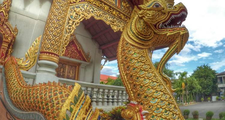 Golden dragon statue at a temple entrance.