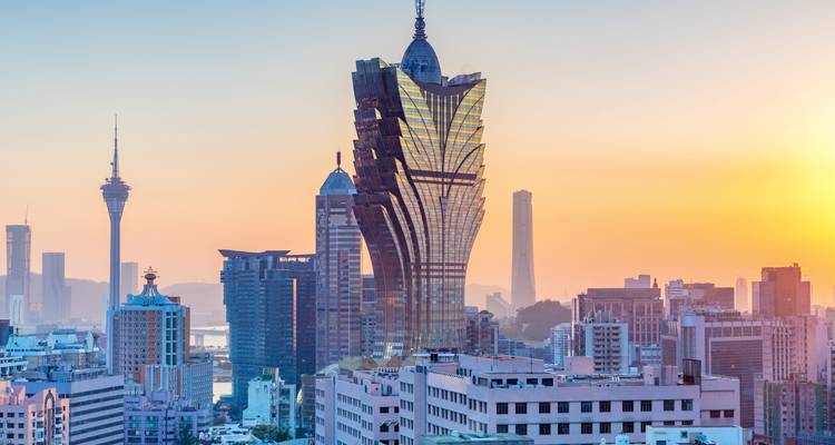 Iconic skyscrapers of Macau under a pastel evening sky.