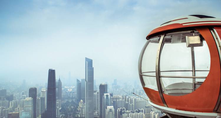 Observation capsule overlooking city skyscrapers.