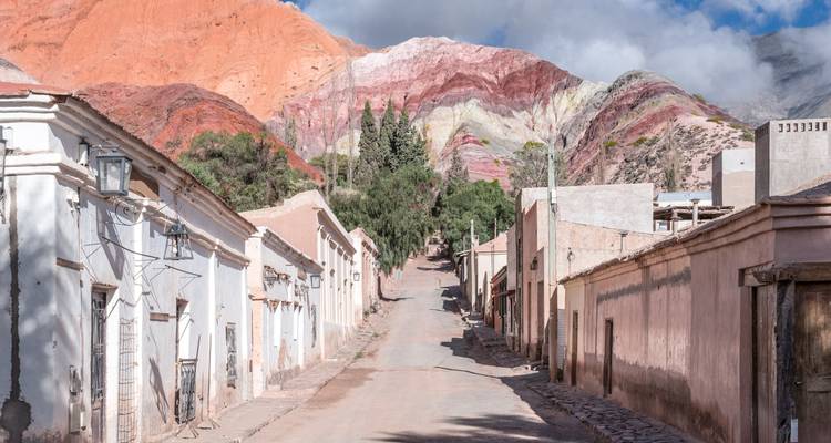 Street view of a village with colorful mountains.