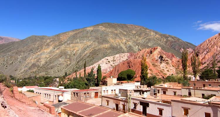 Houses and colorful mountains in the background.