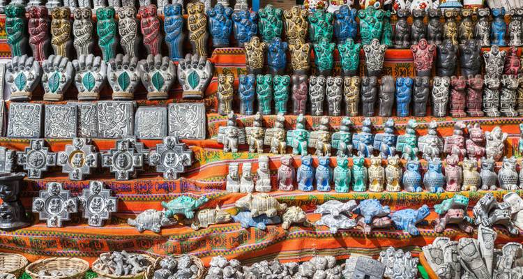 Colorful artisan crafts and small statues for sale.