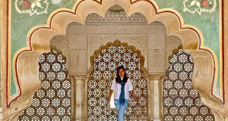 Woman standing in front of ornate architectural details.