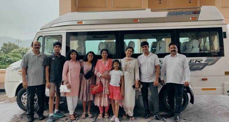 Family photo in front of a large vehicle.