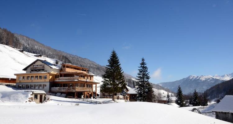 Winter landscape with a lodge in a snowy mountainous area.