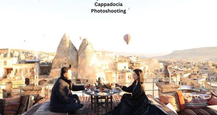 Una pareja disfruta del desayuno en una terraza de Capadocia con globos mientras aparece texto de subtítulo arriba.