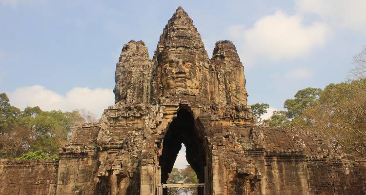 Entrance gate of an ancient temple with sculpted faces.