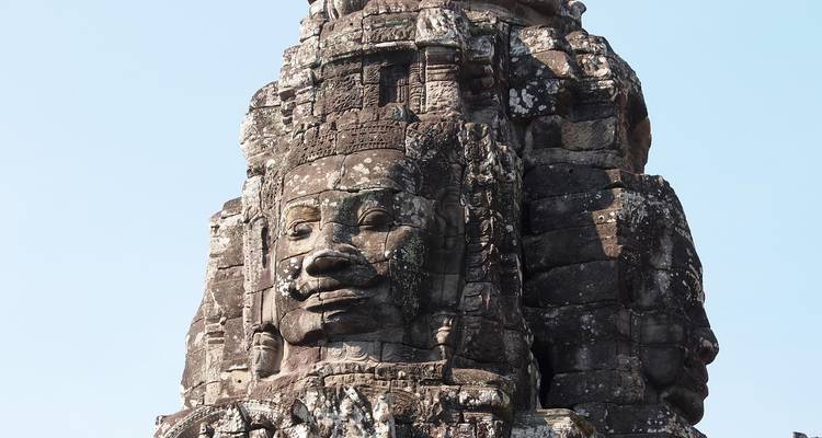Close-up of a sculpted face on an ancient stone structure.