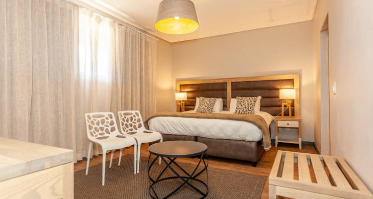 Modern bedroom with a king bed and ample natural light.
