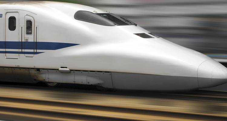 Close-up of a high-speed train moving at a fast pace.
