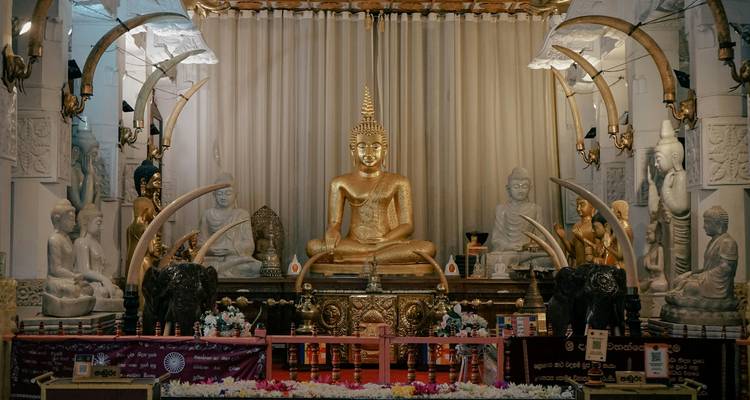 A golden Buddha statue with other religious artifacts.
