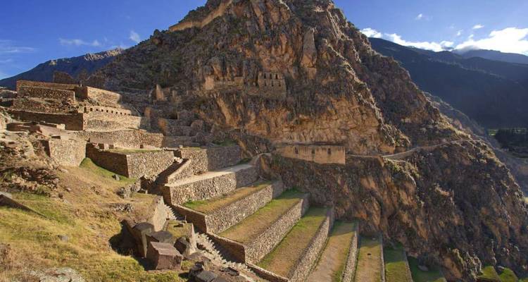 Terraced Incan ruins set against a steep mountainside.