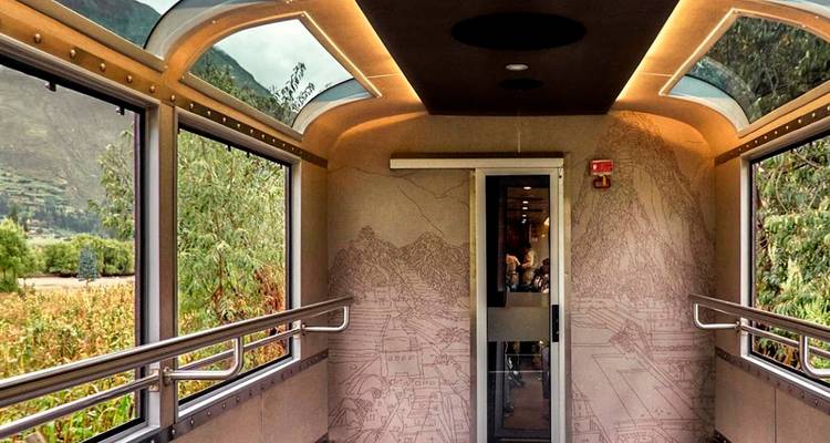 Interior of a train with large windows offering scenic views.