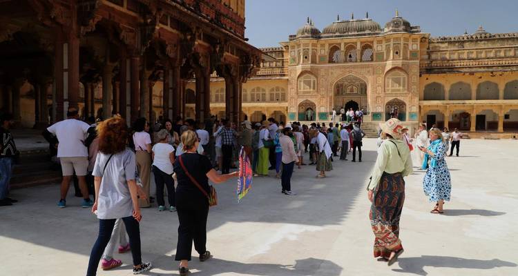 Tourists exploring a fort with intricate architecture