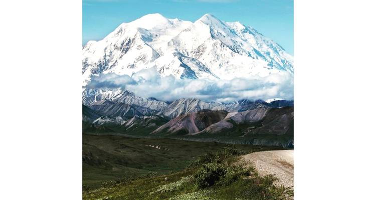 A majestic view of Denali with snow-covered peaks and rugged terrain.