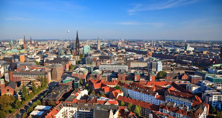 Cityscape aerial view with mix of old and modern buildings.