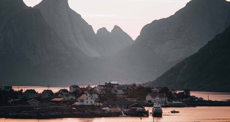 Village with mountains at sunset.