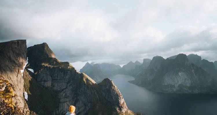 Person looking at mountains over a fjord.
