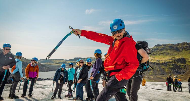 Escalade de glace en groupe sur un glacier, guide en veste rouge en tête.