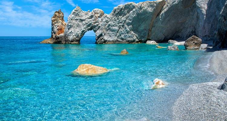 Turquoise sea with unique rock formations and bright blue sky.