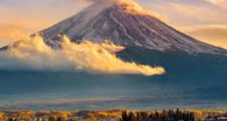 Le mont Fuji avec des nuages et un coucher de soleil coloré.