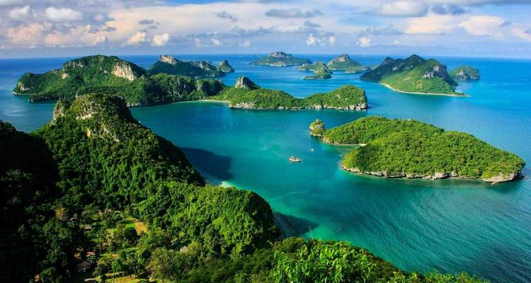 Scenic aerial view of a group of lush islands surrounded by azure water.