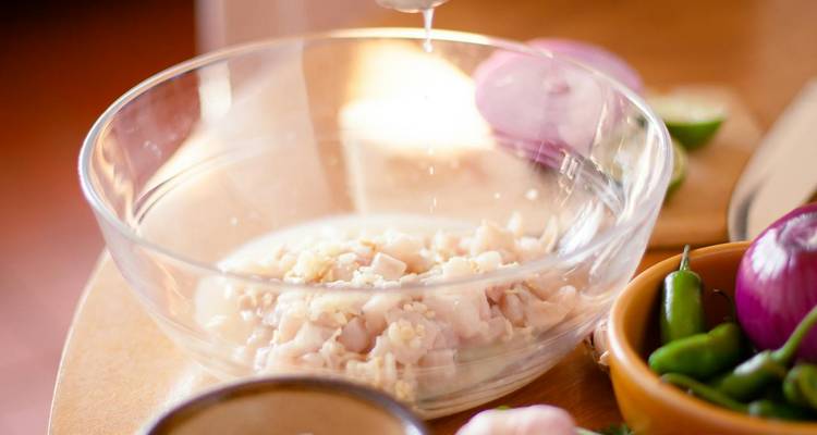 Cooking preparation of ceviche with various ingredients.